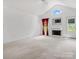 Spacious living room with cathedral ceilings, white fireplace, and lots of light from the windows and the white paint at 1028 Swaying Oats Dr, York, SC 29745
