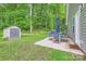 Inviting backyard patio with outdoor seating, a storage shed, and lush greenery at 105 W 17Th St, Salisbury, NC 28144