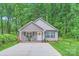 Inviting single-story home featuring a cozy front porch with rocking chairs, a pristine walkway, and a patriotic US flag at 105 W 17Th St, Salisbury, NC 28144