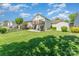 A spacious, grassy backyard featuring a deck, patio area, and a storage shed at 1076 Braxton Dr, Concord, NC 28025