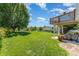 Large backyard with manicured lawn, mature trees, and a lake view at 1076 Braxton Dr, Concord, NC 28025