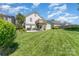Well-maintained backyard with a lush lawn, deck, and patio area for outdoor enjoyment at 1076 Braxton Dr, Concord, NC 28025