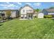 Spacious backyard featuring a manicured lawn and back deck with outdoor furniture at 1076 Braxton Dr, Concord, NC 28025