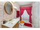 Cozy bathroom featuring a vanity with a sink, patterned wallpaper, and a shower with curtain at 1076 Braxton Dr, Concord, NC 28025