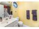 Bright bathroom featuring a single sink vanity, octagon window, and coordinated towels at 1076 Braxton Dr, Concord, NC 28025