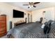 Bedroom featuring a large bed with black linens, a dark wood dresser, and a TV at 1076 Braxton Dr, Concord, NC 28025