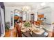 Open dining room area with hardwood floors adjacent to living room and kitchen at 1076 Braxton Dr, Concord, NC 28025