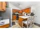 Kitchen with warm wood cabinetry, an island with bar stool seating, and white countertops at 1076 Braxton Dr, Concord, NC 28025