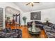 Spacious living room with hardwood floors that flows into the adjacent dining area for entertaining at 1076 Braxton Dr, Concord, NC 28025
