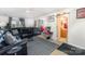 Comfortable living area with a plush sectional sofa, stylish rug, and an open flow to bathroom at 1076 Braxton Dr, Concord, NC 28025
