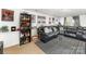 Inviting living room with a sectional sofa, striped rug, and a well-stocked bar area at 1076 Braxton Dr, Concord, NC 28025