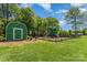 Community playground featuring a slide, swings, and green space at 1076 Braxton Dr, Concord, NC 28025