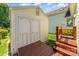 Charming storage shed with double doors and adjacent wooden deck at 1076 Braxton Dr, Concord, NC 28025