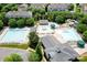 Aerial view of the community pool and water slide, surrounded by greenery, chairs, and umbrellas at 10911 Skymont Dr, Huntersville, NC 28078