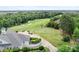 Aerial view of the golf course, with lush greenery and a view of the putting green and manicured fairways at 10911 Skymont Dr, Huntersville, NC 28078