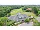 Aerial view of the golf course, showing trees, golf carts, and a beautiful white clubhouse at 10911 Skymont Dr, Huntersville, NC 28078