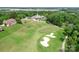 Expansive aerial view of the golf course, revealing lush greenery, sand traps, clubhouse, and a serene atmosphere at 10911 Skymont Dr, Huntersville, NC 28078