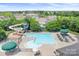 An aerial shot shows the community pool with a slide and lounge seating surrounded by the neighborhood at 10911 Skymont Dr, Huntersville, NC 28078