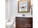 Bathroom featuring a wood vanity, mirror, and neutral color palette at 10911 Skymont Dr, Huntersville, NC 28078