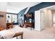 A large room with guitars and a TV features a window and an open doorway, suggesting versatile space at 10911 Skymont Dr, Huntersville, NC 28078