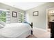 A serene bedroom with lots of light features a bed with white bedding and framed art, creating a calm space at 10911 Skymont Dr, Huntersville, NC 28078