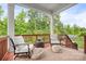 A covered deck with outdoor seating, a table and an umbrella offers a cozy outdoor space for relaxing or entertaining at 10911 Skymont Dr, Huntersville, NC 28078