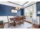 Elegant dining room with blue walls, wainscoting, and a stylish chandelier fixture at 10911 Skymont Dr, Huntersville, NC 28078
