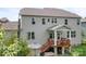Exterior view of back of home with patio, deck, staircase, and wooded area at 10911 Skymont Dr, Huntersville, NC 28078