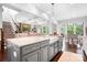 Spacious kitchen featuring a grey island with seating, stainless steel appliances, and hardwood floors at 10911 Skymont Dr, Huntersville, NC 28078