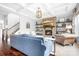 Open living room features coffered ceilings, a stone fireplace, wooden shelves, and hardwood floors at 10911 Skymont Dr, Huntersville, NC 28078