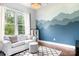 Cozy living room with a white sofa, mountain mural, and natural light, creating a relaxing atmosphere at 10911 Skymont Dr, Huntersville, NC 28078