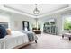 Bright main bedroom with ample space, a lounge chair, and a large TV at 10911 Skymont Dr, Huntersville, NC 28078