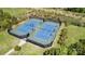 Aerial view of two well-maintained blue and green community tennis courts at 10911 Skymont Dr, Huntersville, NC 28078