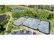 Aerial view of community tennis courts with several players, parking, and a pond at 10911 Skymont Dr, Huntersville, NC 28078
