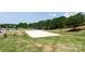 A community sand volleyball court and playground surrounded by a lush lawn at 10911 Skymont Dr, Huntersville, NC 28078