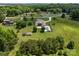 This aerial view showcases the home, its landscaped backyard, and surrounding lush greenery and neighborhood at 1115 Wynnbrook Way, Concord, NC 28027