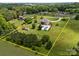 This aerial view shows the property lines of a landscaped backyard with a kidney-shaped pool and lawn at 1115 Wynnbrook Way, Concord, NC 28027