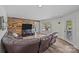 Spacious basement with a rustic accent wall and walkout access to the backyard at 1115 Wynnbrook Way, Concord, NC 28027