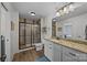 Modern bathroom featuring walk-in shower with glass door, granite countertops, and stylish vanity at 1115 Wynnbrook Way, Concord, NC 28027