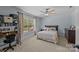 Charming bedroom with neutral tones, carpet, and a bright window overlooking the backyard at 1115 Wynnbrook Way, Concord, NC 28027