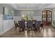 Elegant dining room with modern chandelier, wainscoting and view of backyard at 1115 Wynnbrook Way, Concord, NC 28027