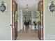 A grand foyer with elegant double doors, hardwood floors, and a view into the living spaces at 1115 Wynnbrook Way, Concord, NC 28027