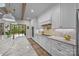 A kitchen with marble countertops, white cabinetry, and modern appliances and a walkout to the deck at 1115 Wynnbrook Way, Concord, NC 28027