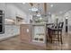 Stylish kitchen island with bar seating, marble accents, and a built-in pet feeding station at 1115 Wynnbrook Way, Concord, NC 28027