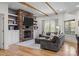 Cozy living room featuring stone fireplace, built-in shelves, and wood beam ceiling at 1115 Wynnbrook Way, Concord, NC 28027