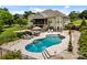 Backyard view of a large in-ground pool with lounge chairs and seating, set in a stone-paved area at 1115 Wynnbrook Way, Concord, NC 28027