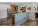 Basement wet bar featuring custom cabinets, stylish countertops and a rustic sliding barn door at 1115 Wynnbrook Way, Concord, NC 28027