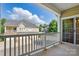 Enjoy a relaxing view from this spacious covered balcony with white railings and a peek into the community at 11209 Lazio Ln # 1, Charlotte, NC 28277