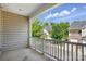 Enjoy a relaxing view from this large, covered balcony with white railings and a peek into the community at 11209 Lazio Ln # 1, Charlotte, NC 28277