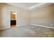 Carpeted bedroom with ensuite bathroom featuring neutral colors, and an open doorway to the connected bathroom at 11209 Lazio Ln # 1, Charlotte, NC 28277
